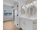 A stunning bathroom with hardwood floors, gold fixtures, and a well lit mirror at 2110 Los Feliz St # 1037, Las Vegas, NV 89156