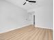 Bedroom features light wood flooring, access to en-suite bathroom, and a modern ceiling fan at 2110 Los Feliz St # 1037, Las Vegas, NV 89156