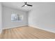 A well-lit bedroom with a modern ceiling fan, light wood flooring, and a window at 2110 Los Feliz St # 1037, Las Vegas, NV 89156