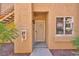 Front entrance featuring a security screen door with a warning sign about surveillance cameras at 2110 Los Feliz St # 1037, Las Vegas, NV 89156