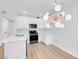 Contemporary kitchen and eating area featuring stainless appliances, bright white cabinets, and stylish light fixture at 2110 Los Feliz St # 1037, Las Vegas, NV 89156
