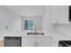Updated kitchen showcasing stainless appliances, bright white cabinetry, gold hardware, and a quartz counter at 2110 Los Feliz St # 1037, Las Vegas, NV 89156