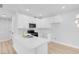 Modern kitchen with white cabinets, quartz countertops, stainless steel appliances, and gold hardware accents at 2110 Los Feliz St # 1037, Las Vegas, NV 89156