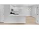 Bright living room with wood floors and a view of the open kitchen at 2110 Los Feliz St # 1037, Las Vegas, NV 89156