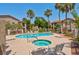 A large outdoor pool and jacuzzi with lounge chairs provides a relaxing and resort-like community space at 2110 Los Feliz St # 1037, Las Vegas, NV 89156