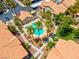 Aerial view of a sparkling community pool with palm trees and lounge chairs surrounded by lush landscaping at 2110 Los Feliz St # 1037, Las Vegas, NV 89156