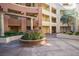 Condo courtyard featuring mature landscaping with planter, architectural details, and walkways at 220 E Flamingo Rd # 129, Las Vegas, NV 89169