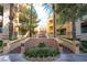 View of the condo entrance featuring well-maintained landscaping and access to the building at 220 E Flamingo Rd # 129, Las Vegas, NV 89169