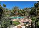 Community pool surrounded by palm trees with lounge chairs to relax and soak up the sun at 220 E Flamingo Rd # 129, Las Vegas, NV 89169