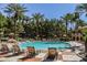 Community pool surrounded by palm trees with lounge chairs to relax and soak up the sun at 220 E Flamingo Rd # 129, Las Vegas, NV 89169