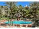 Community pool surrounded by palm trees with lounge chairs to relax and soak up the sun at 220 E Flamingo Rd # 129, Las Vegas, NV 89169