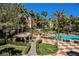 Community pool surrounded by palm trees and lounge chairs to relax and soak up the sun at 220 E Flamingo Rd # 129, Las Vegas, NV 89169