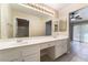 Double sink bathroom with vanity, large mirror with vanity lights, and neutral paint at 2251 Wigwam Pkwy # 923, Henderson, NV 89074