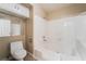 Bathroom featuring a toilet and a shower and tub combination with white tile surround at 2251 Wigwam Pkwy # 923, Henderson, NV 89074