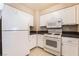 Well-lit kitchen featuring modern appliances, white cabinets and tile flooring at 2251 Wigwam Pkwy # 923, Henderson, NV 89074