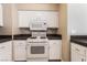 Well-lit kitchen featuring modern appliances, white cabinets and tile flooring at 2251 Wigwam Pkwy # 923, Henderson, NV 89074