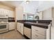 Bright kitchen featuring white cabinets, tile floors, and granite countertops at 2251 Wigwam Pkwy # 923, Henderson, NV 89074