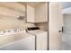 Functional laundry area with a washing machine, dryer, storage shelves and an access door at 2251 Wigwam Pkwy # 923, Henderson, NV 89074