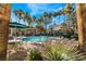 Resort-style pool area with lounge chairs, gazebo, and lush palm trees in a well-maintained community at 2251 Wigwam Pkwy # 923, Henderson, NV 89074