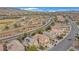 An aerial view showcases homes with desert landscaping near a park and playground at 2445 Rue Royale, Henderson, NV 89044