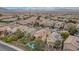 An aerial view of a neighborhood home with a pool, spa, covered patio, and mature landscaping at 2445 Rue Royale, Henderson, NV 89044