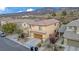 An aerial view of the home featuring mature landscaping and spectacular mountain views at 2445 Rue Royale, Henderson, NV 89044