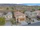 An aerial view of the home featuring mature landscaping and spectacular mountain views at 2445 Rue Royale, Henderson, NV 89044