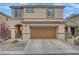 A charming two-story home boasting a neutral-toned exterior, well-maintained landscaping, and a two-car garage at 2445 Rue Royale, Henderson, NV 89044