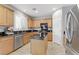 Kitchen features granite countertops, stainless steel appliances, island, and wooden cabinets at 2445 Rue Royale, Henderson, NV 89044