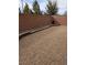 A low-maintenance backyard featuring a gravel ground cover, brick walls, and decorative rock bordering at 2539 Ballatore St, Henderson, NV 89044