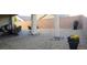 Outdoor space showcasing gravel landscaping with a mix of potted plants and seating area with a partially-covered patio at 2539 Ballatore St, Henderson, NV 89044