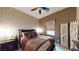 A well-lit bedroom featuring a plush bed with decorative pillows, and modern decor at 2539 Ballatore St, Henderson, NV 89044