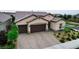 Attractive single-story home with a three-car garage, brick driveway, and well-maintained landscaping at 2539 Ballatore St, Henderson, NV 89044