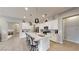 Modern kitchen with white cabinetry, stainless steel appliances, and a center island with pendant lighting at 2539 Ballatore St, Henderson, NV 89044