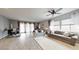 Bright living room with neutral walls, wood-look floors, and stylish furniture with a large window at 2539 Ballatore St, Henderson, NV 89044