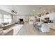 Open-concept living space featuring a kitchen island with seating and a comfortable living area at 2539 Ballatore St, Henderson, NV 89044