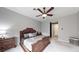 Comfortable main bedroom featuring an ornate bed frame, ceiling fan, and soft neutral tones throughout at 2539 Ballatore St, Henderson, NV 89044