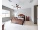 Elegant main bedroom with a classic bed frame, a ceiling fan, and comfortable furnishings, and soft carpeting at 2539 Ballatore St, Henderson, NV 89044