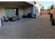 Covered patio and gravel yard with ample space for outdoor relaxation and activities, complimented by furniture at 2539 Ballatore St, Henderson, NV 89044