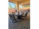Relaxing outdoor seating area with comfortable chairs and a stylish table on the brick-paved patio at 2539 Ballatore St, Henderson, NV 89044