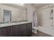 Bathroom features a double sink vanity with granite countertop and a shower-tub combo at 2901 Bahama Yellow Ave, North Las Vegas, NV 89086