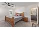 Well-lit bedroom with a wooden bed frame, neutral decor, and ensuite bathroom at 2901 Bahama Yellow Ave, North Las Vegas, NV 89086