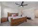 Large bedroom with wooden furniture, neutral carpet, and ensuite bathroom entrance at 2901 Bahama Yellow Ave, North Las Vegas, NV 89086