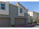 Exterior elevation of townhomes, showcasing a contemporary design and attached garages at 2901 Bahama Yellow Ave, North Las Vegas, NV 89086