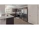 Modern kitchen features stainless steel appliances, dark wood cabinets, and granite countertops at 2901 Bahama Yellow Ave, North Las Vegas, NV 89086