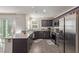 Well-lit kitchen featuring stainless steel appliances, sleek dark cabinets, and a breakfast bar at 2901 Bahama Yellow Ave, North Las Vegas, NV 89086