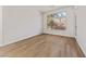 Cozy bedroom with wood floors, a large window, and neutral decor at 3033 Bonnie Rock Dr, Las Vegas, NV 89134
