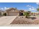 Charming single-story home featuring desert landscaping, a two-car garage and a neutral color palette at 3033 Bonnie Rock Dr, Las Vegas, NV 89134