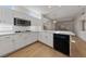 Open kitchen featuring white cabinetry, quartz countertops, stainless appliances, and wood flooring at 3033 Bonnie Rock Dr, Las Vegas, NV 89134