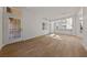 Open-concept living area with wood floors, white walls, and views into the adjoining kitchen at 3033 Bonnie Rock Dr, Las Vegas, NV 89134